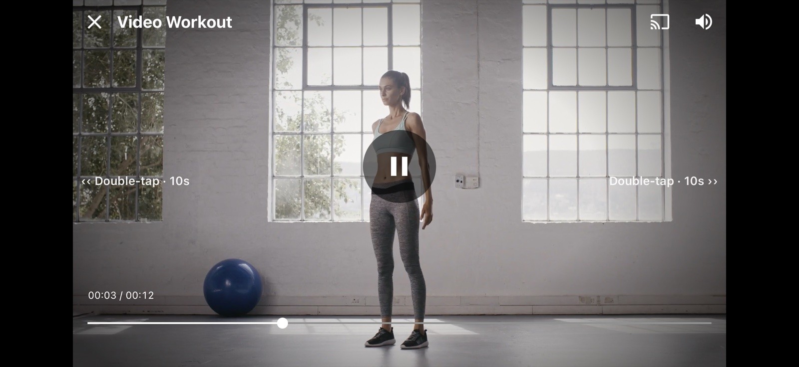A workout video playing in landscape, with "Double-tap · 10s" hints on the left and right sides of the screen